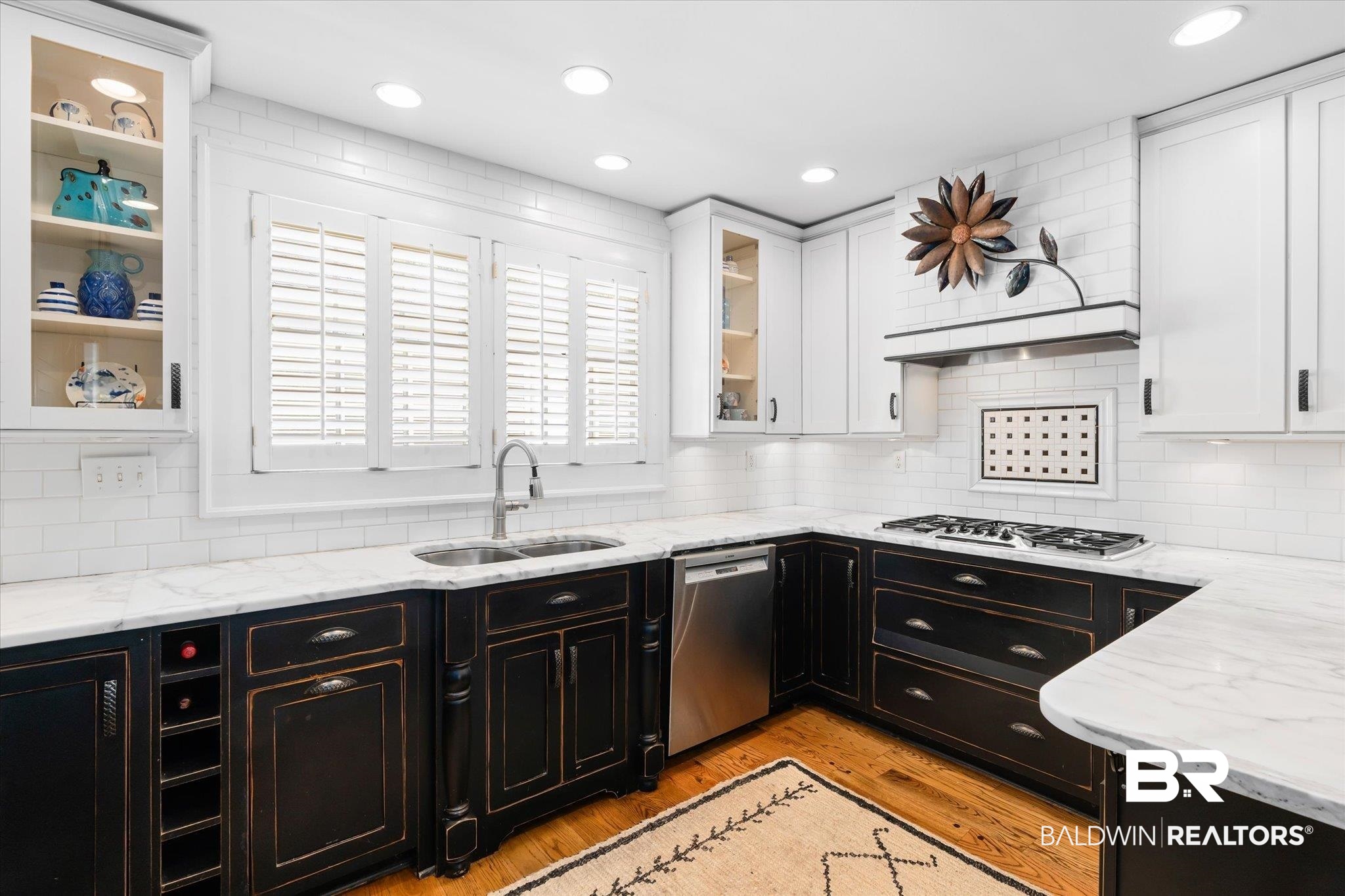 202 Woodlands Avenue Mobile, AL 36607 - Photo 12 of 53 Kitchen with white gas stovetop, light wood-type flooring, sink, stainless steel dishwasher, and white cabinets