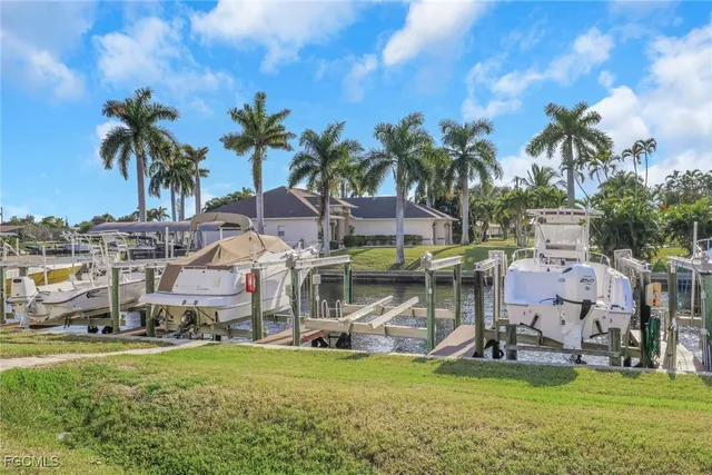 a view of a house with a garden and sitting area