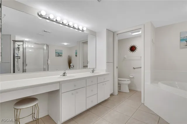 a spacious bathroom with a double vanity sink a mirror and a bathtub