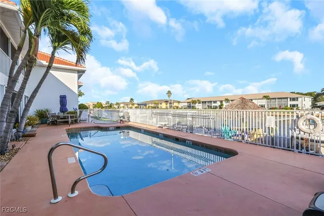 a view of swimming pool with outdoor seating and city view