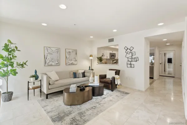 a living room with furniture and a potted plant