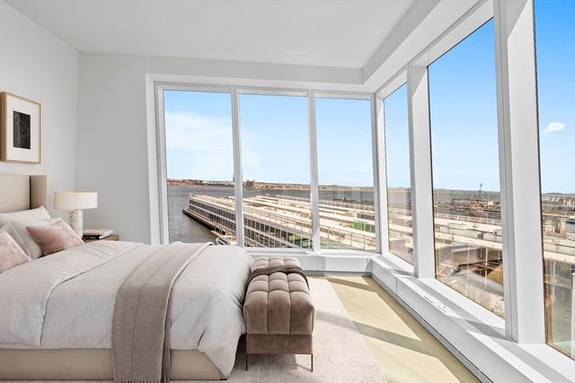 a bedroom with a bed and a larger window