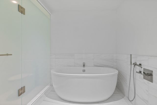 a white bath tub sitting in a bathroom