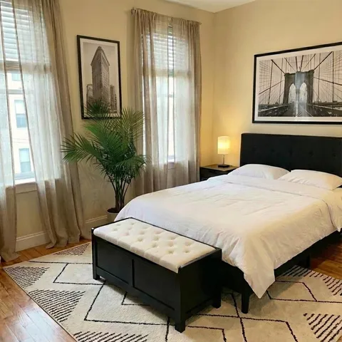 a bed sitting in a bedroom next to a window