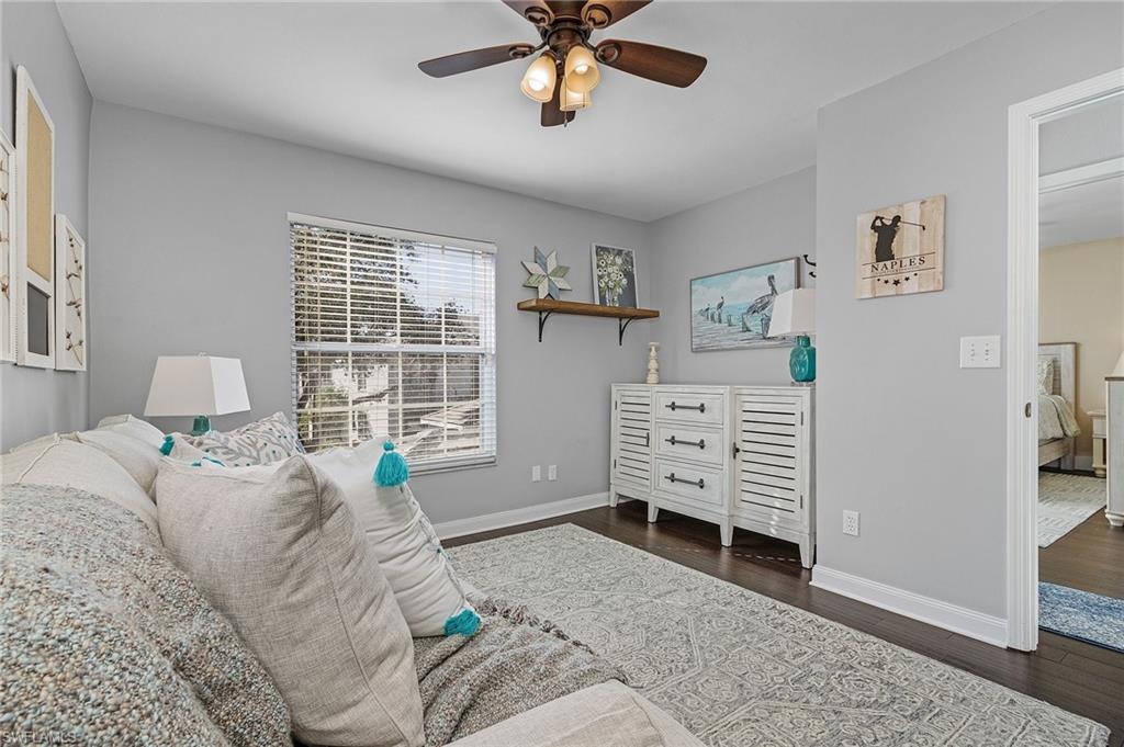3785 Fieldstone Boulevard, Unit 208 Naples, FL 34109 - Photo 12 of 26 Living area featuring ceiling fan, and wood floors
