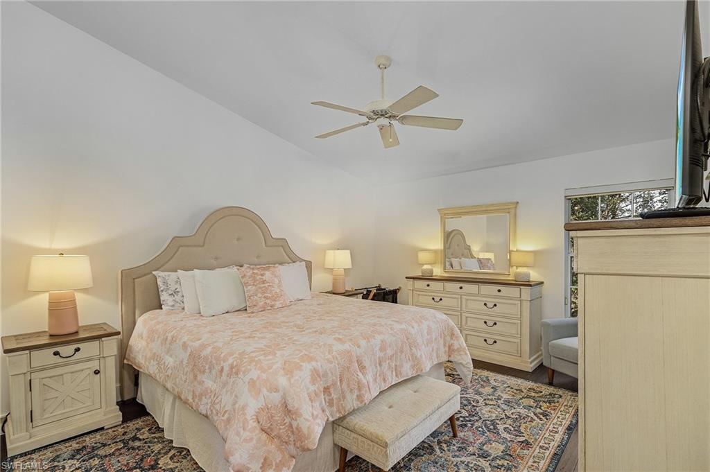 3785 Fieldstone Boulevard, Unit 208 Naples, FL 34109 - Photo 13 of 26 Bedroom featuring ceiling fan and wood floors