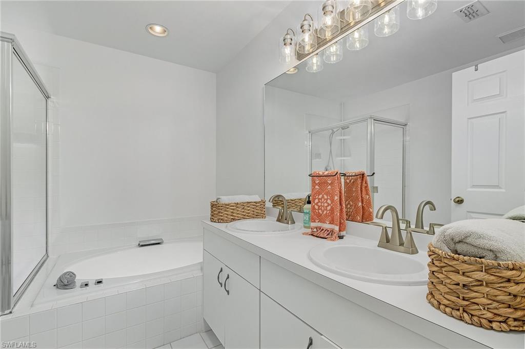 3785 Fieldstone Boulevard, Unit 208 Naples, FL 34109 - Photo 15 of 26 Full bath featuring a stall shower, sunken tub and dual sinks