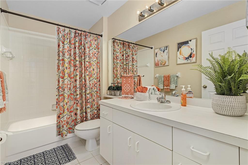 3785 Fieldstone Boulevard, Unit 208 Naples, FL 34109 - Photo 18 of 26 Full bathroom with shower / tub combo with curtain, vanity, toilet, and tile patterned floors