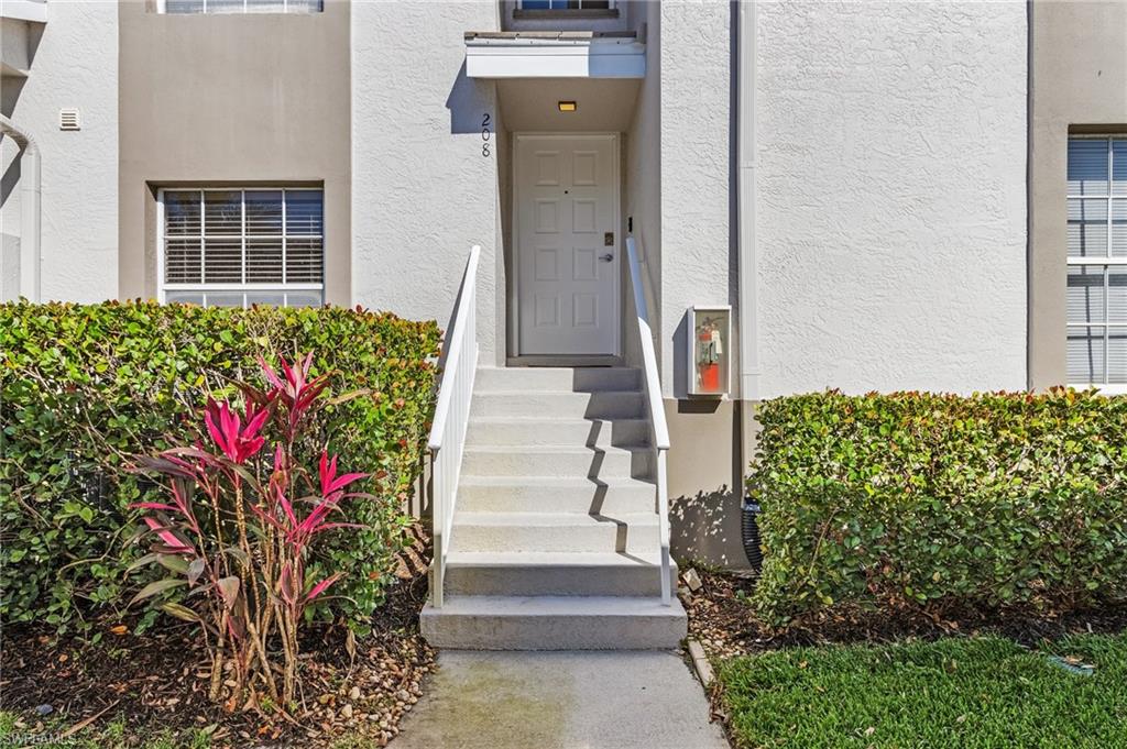 3785 Fieldstone Boulevard, Unit 208 Naples, FL 34109 - Photo 20 of 26 View of exterior entry with stucco siding