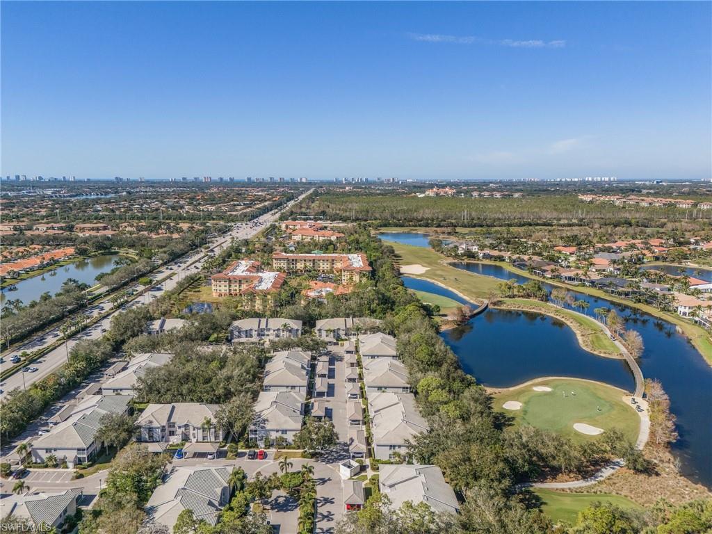 3785 Fieldstone Boulevard, Unit 208 Naples, FL 34109 - Photo 26 of 26 Drone / aerial view featuring a water view, view of golf course, and a residential view
