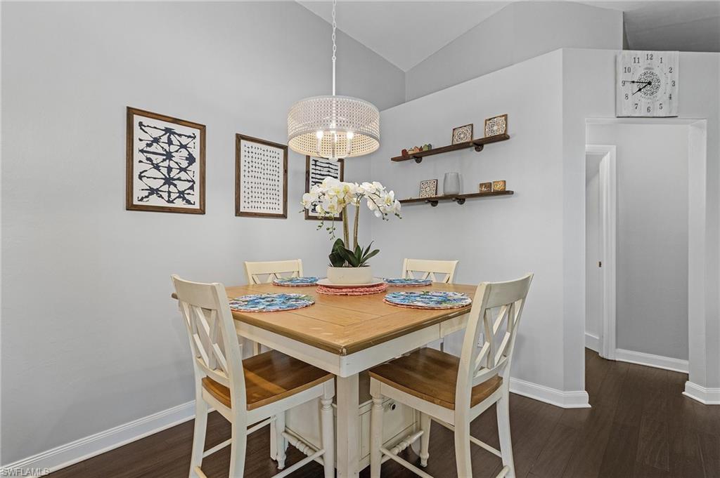 3785 Fieldstone Boulevard, Unit 208 Naples, FL 34109 - Photo 10 of 26 Dining room vaulted ceiling, and wood floors