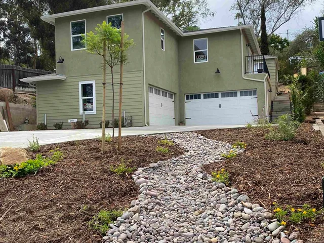 a front view of a house with garden