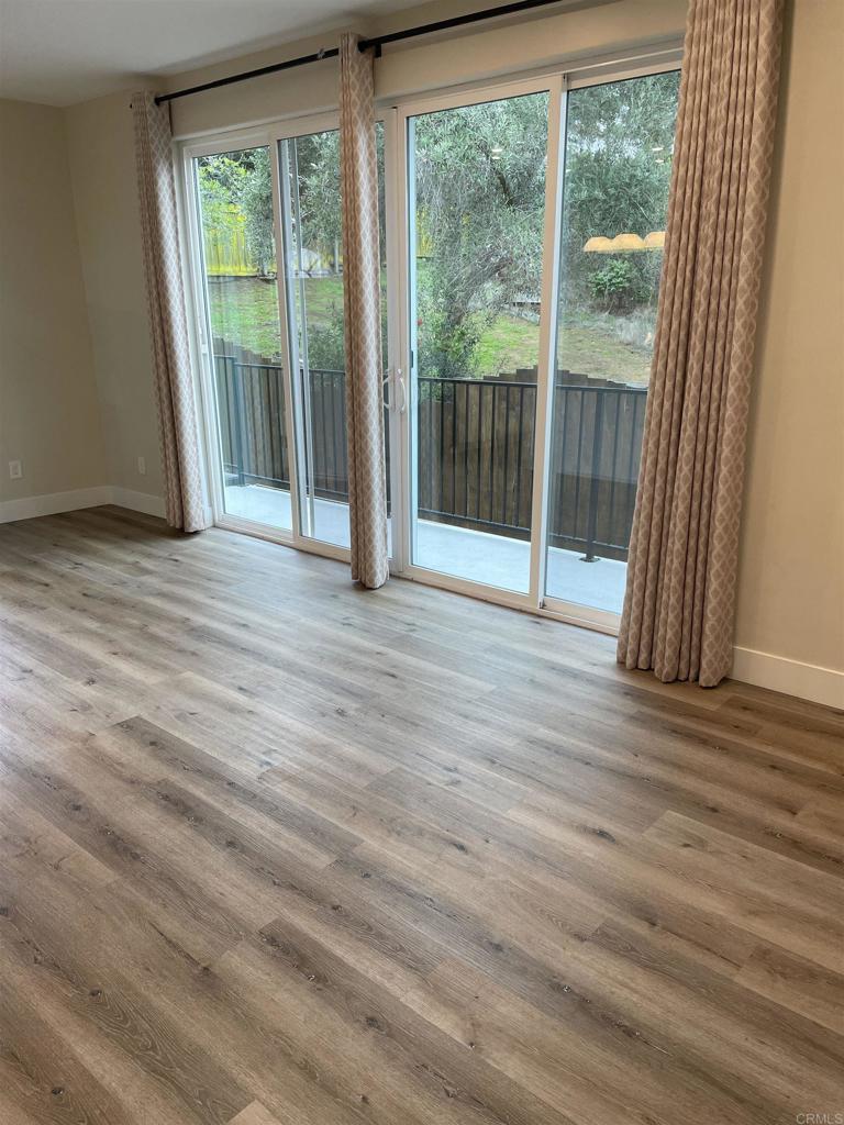 8545 Lemon Avenue, Unit 1 La Mesa, CA 91941 - Photo 19 of 28 a view of empty room with wooden floor and floor to ceiling window