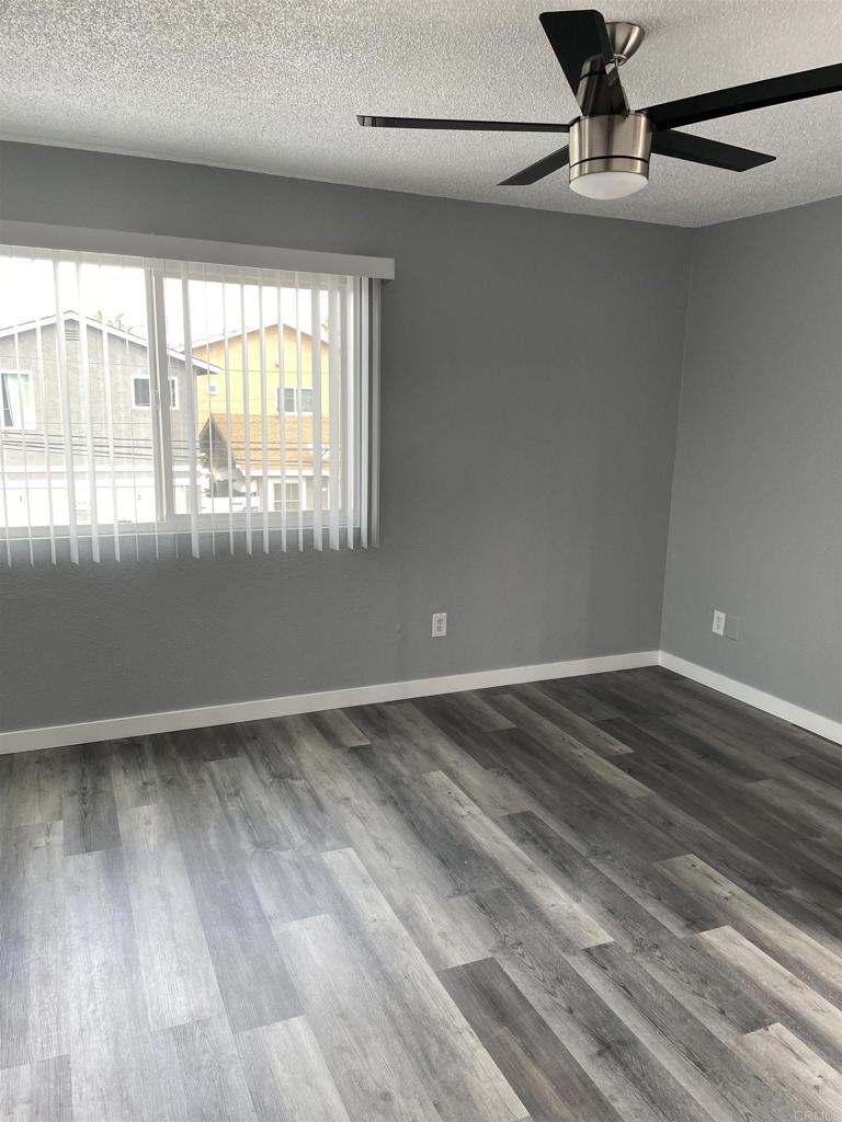 8545 Lemon Avenue, Unit 1 La Mesa, CA 91941 - Photo 22 of 28 a view of an empty room with wooden floor and a window