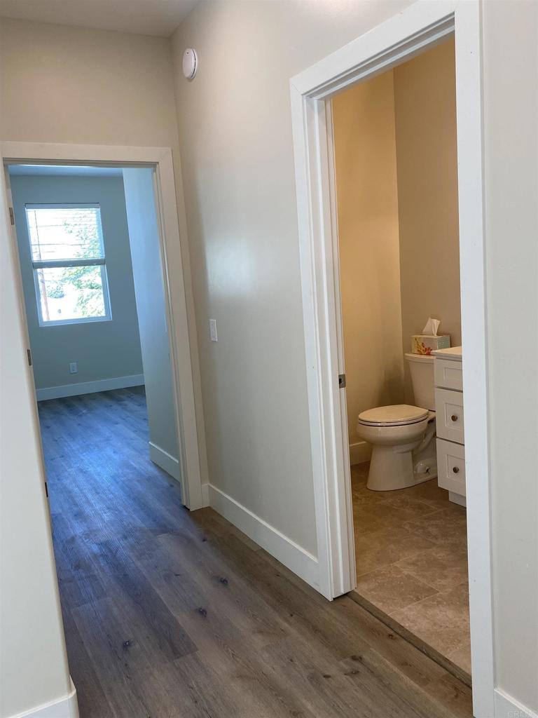 8545 Lemon Avenue, Unit 1 La Mesa, CA 91941 - Photo 9 of 28 a view of a room with wooden floor and a bathroom