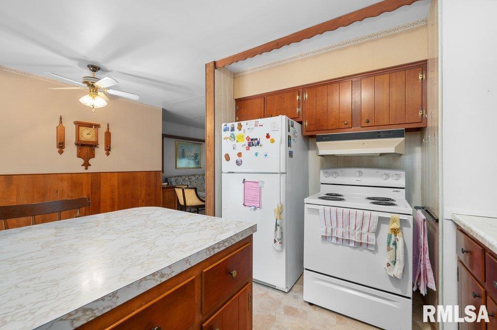513 12th Avenue Hampton, IL 61256 - Photo 11 of 35 a kitchen with stainless steel appliances granite countertop a refrigerator a stove and a sink