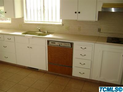 2193 West Visalia Road Exeter, CA 93221 - Photo 8 of 23 a kitchen with granite countertop white cabinets and sink