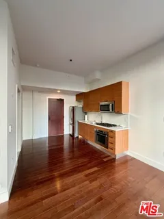 a kitchen with stainless steel appliances granite countertop a stove and a wooden floors