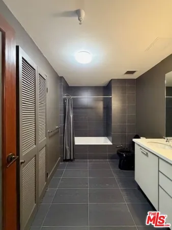 a bathroom with a mirror and a shower