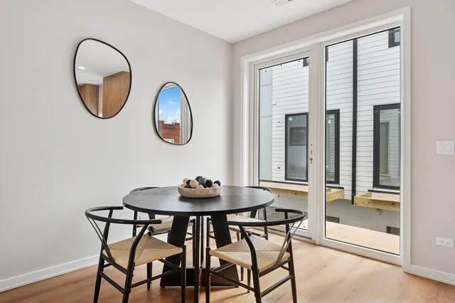 a dining room with furniture and a mirror