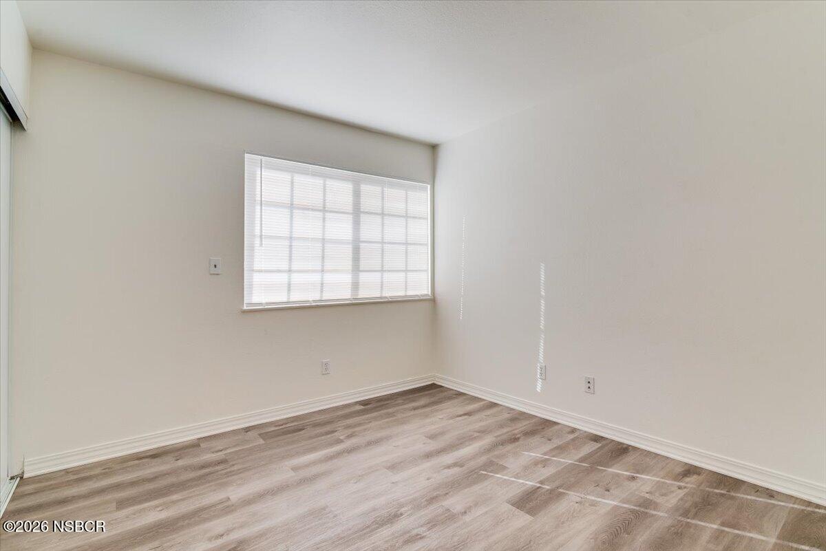 321 North Z Street Lompoc, CA 93436 - Photo 16 of 33 an empty room with wooden floor and windows