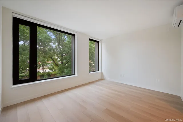 a bedroom with a bed and large windows