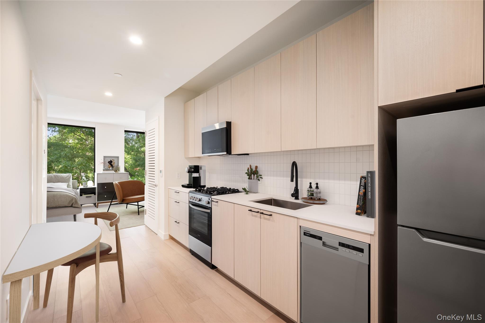 15310-unit #804 15310-unit Avenue Queens, NY 11432 - Photo 8 of 19 a kitchen with a sink a stove a refrigerator and cabinets