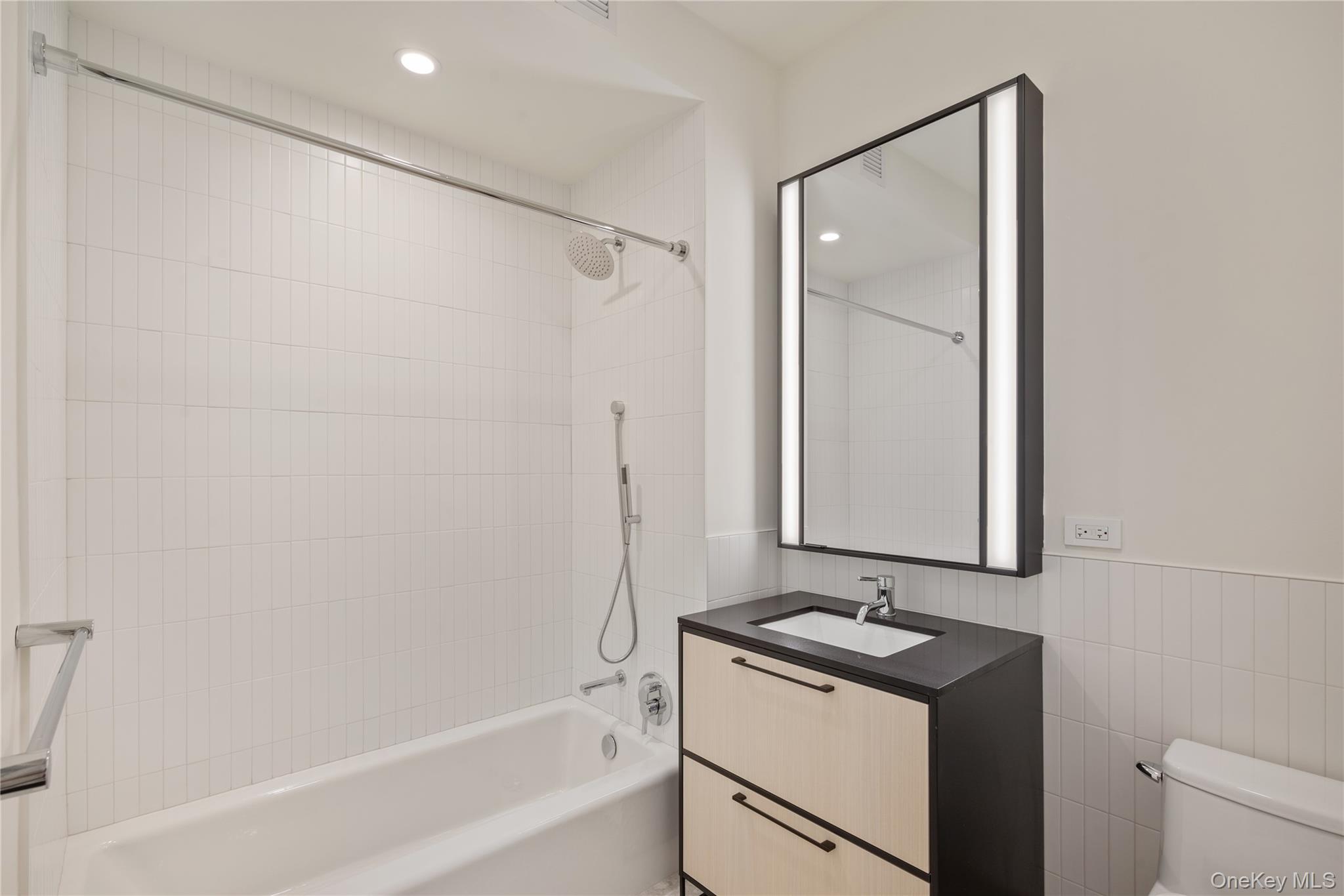 15310-unit #804 15310-unit Avenue Queens, NY 11432 - Photo 9 of 19 a bathroom with a sink and a mirror