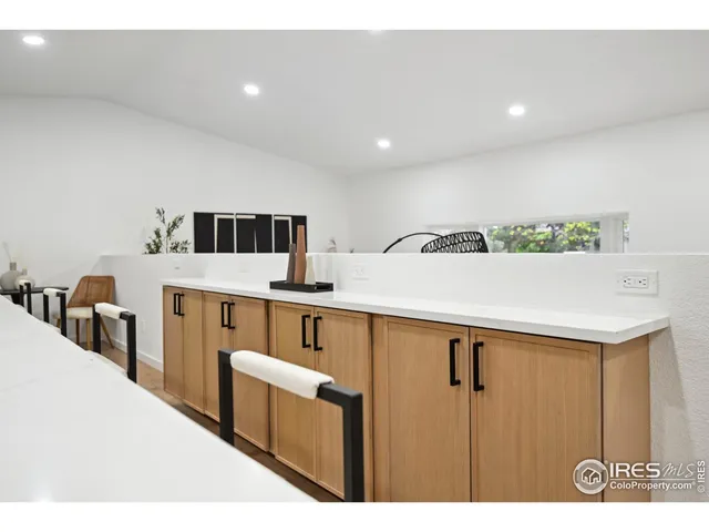a kitchen with stainless steel appliances a sink a refrigerator and wooden floor