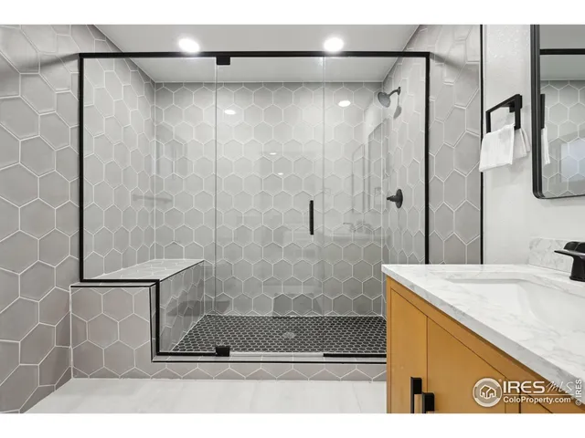 a bathroom with a shower and a sink