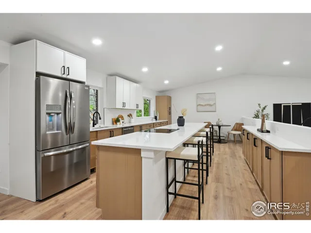 a kitchen with counter top space refrigerator sink and cabinets