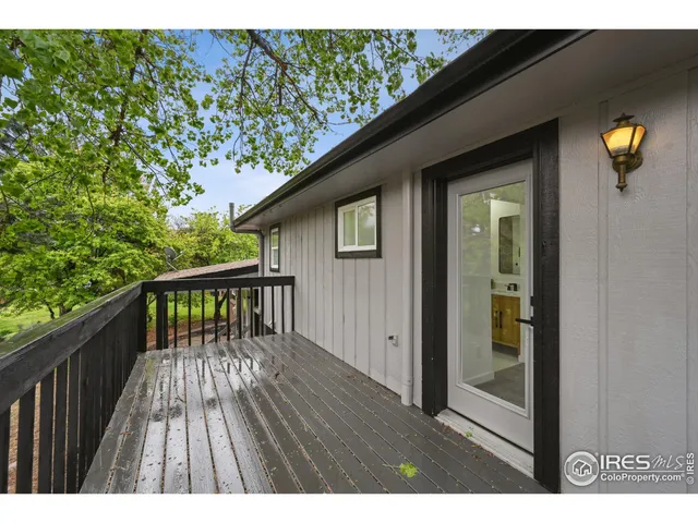 a view of backyard with a deck and wooden floor