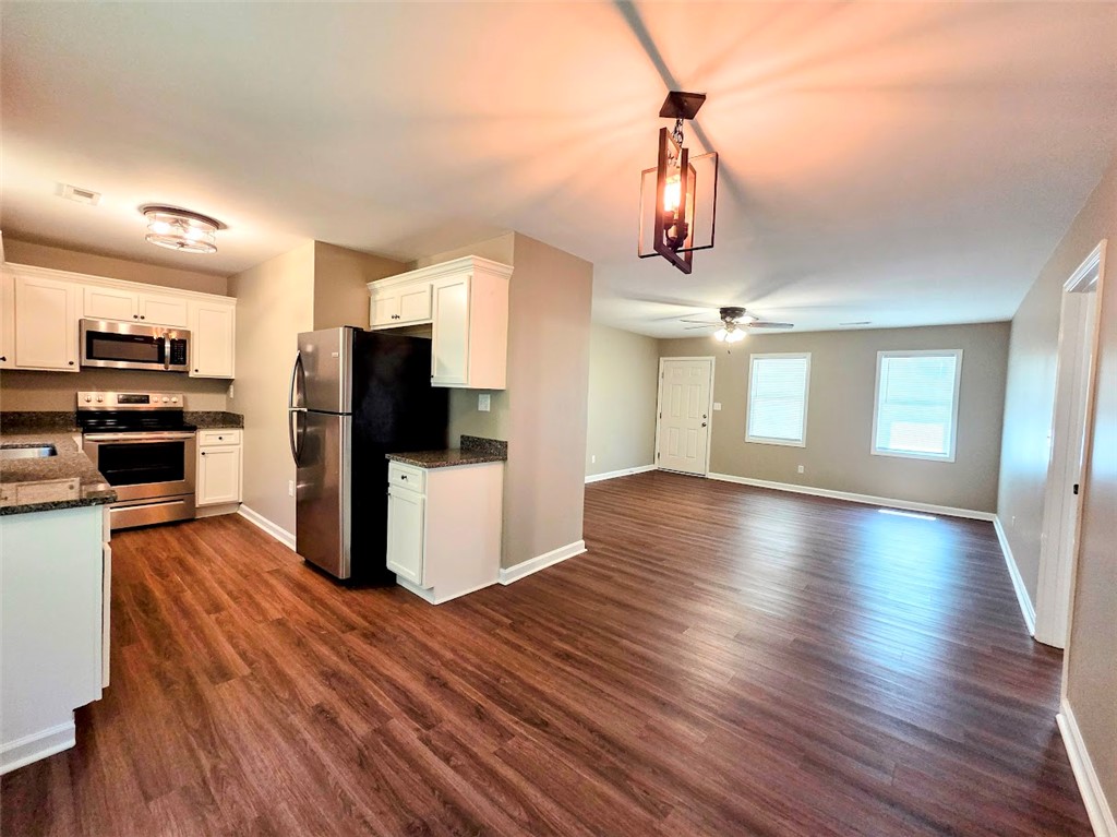 509 Elrod Road Piedmont, SC 29673 - Photo 14 of 28 A well-designed kitchen and living area feature resilient laminate flooring throughout, creating a harmonious and functional open space.