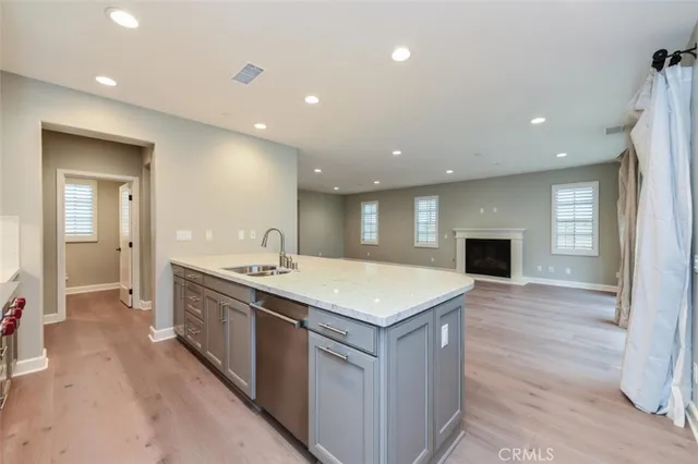 a kitchen with a sink and a stove top oven