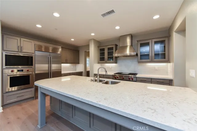 a kitchen with a stove a sink and a refrigerator