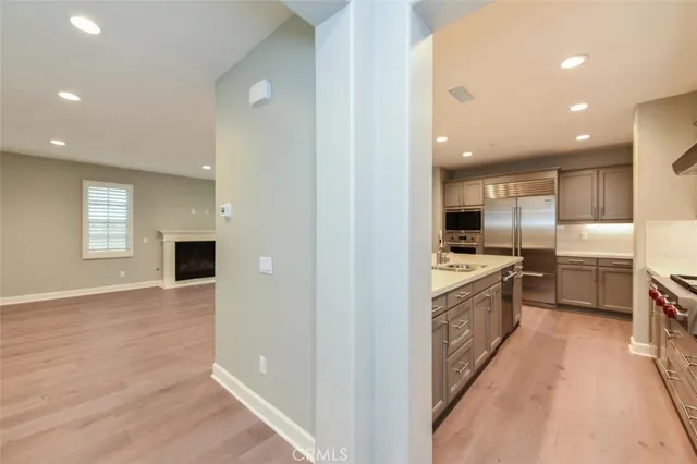 a large kitchen with granite countertop a large counter top stainless steel appliances and cabinets