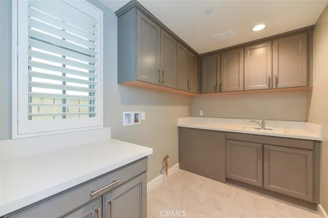 a kitchen with a sink cabinets and window