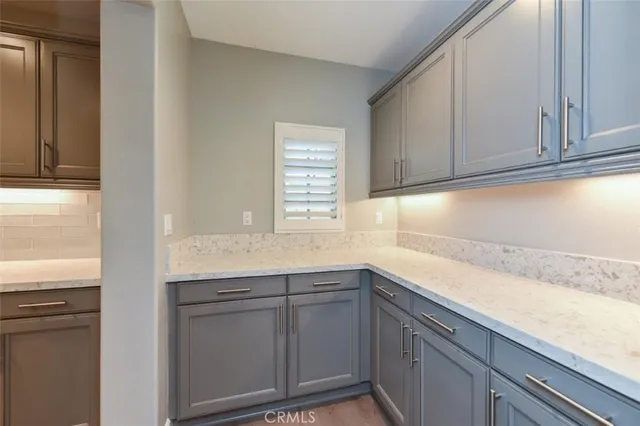 a kitchen with granite countertop cabinets stainless steel appliances and a window