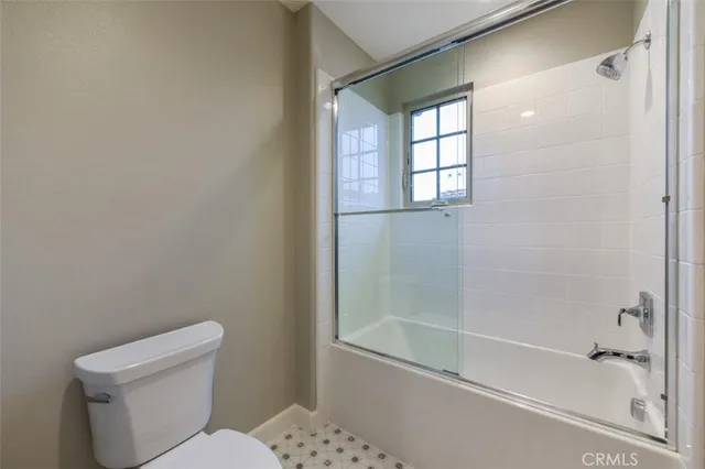 a bathroom with a toilet and shower
