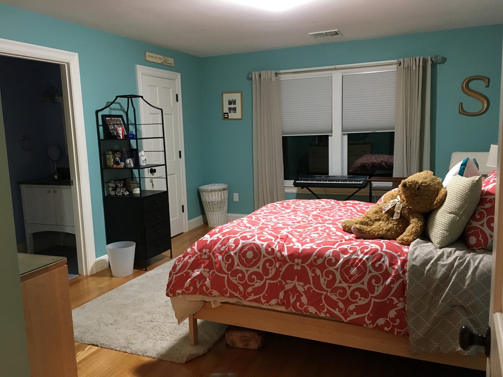 3 Fairbanks Road Lexington, MA 02421 - Photo 15 of 18 a bedroom with a bed table and flat screen tv