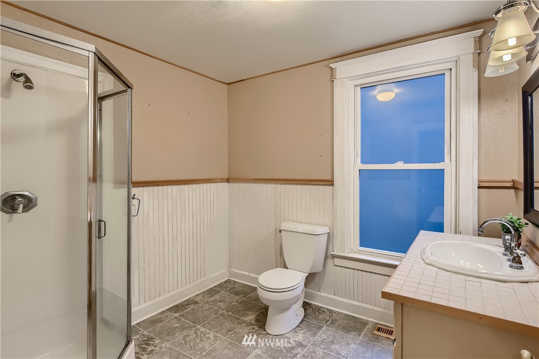 10308 Northeast 186th Street Bothell, WA 98011 - Photo 11 of 25 a bathroom with a toilet a sink and shower