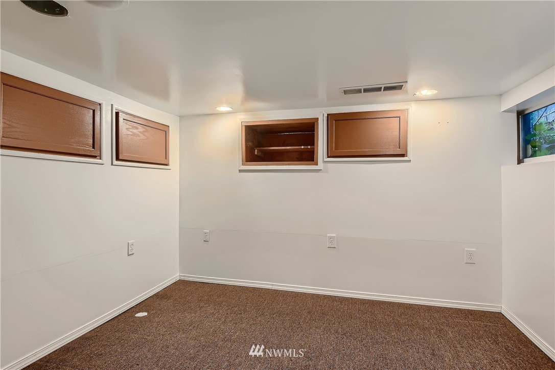 10308 Northeast 186th Street Bothell, WA 98011 - Photo 16 of 25 a view of an empty room with window and cabinet