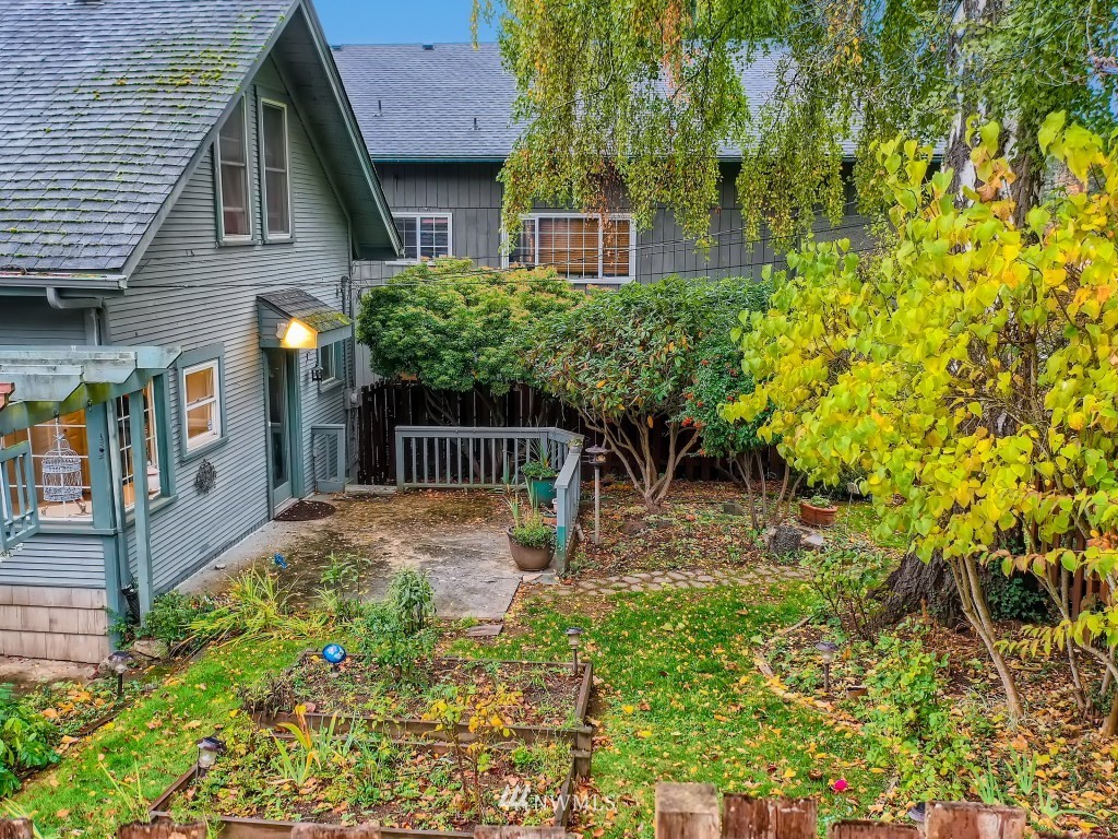 10308 Northeast 186th Street Bothell, WA 98011 - Photo 19 of 25 a view of a brick house with a yard plants and large tree