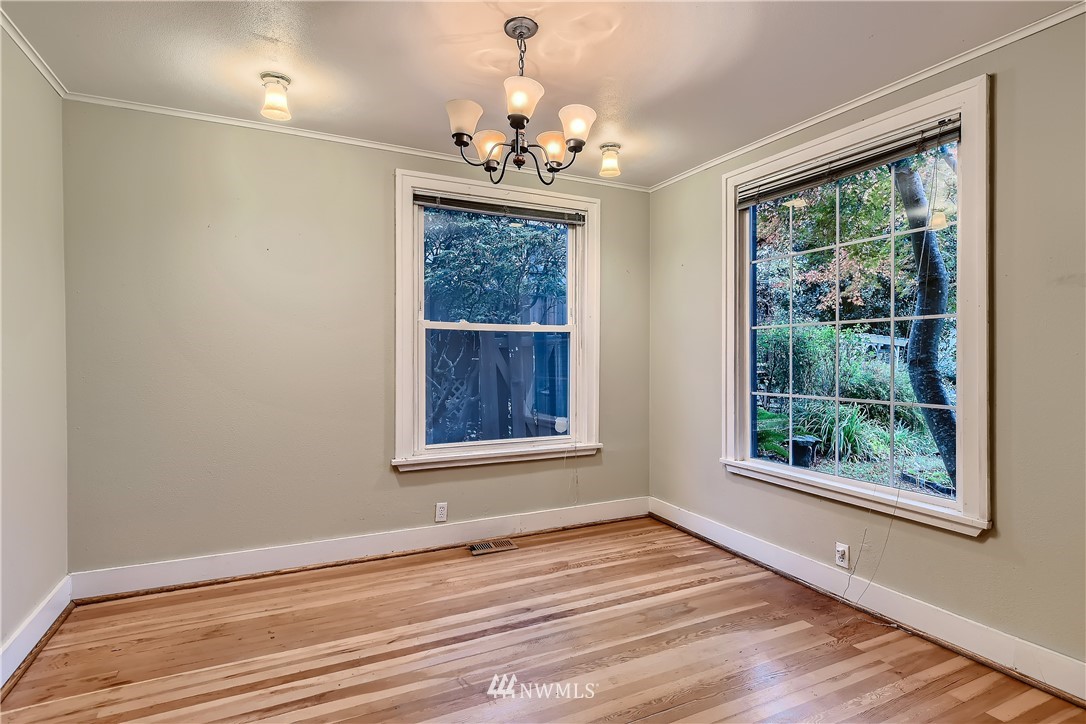 10308 Northeast 186th Street Bothell, WA 98011 - Photo 9 of 25 a view of an empty room with wooden floor and a window
