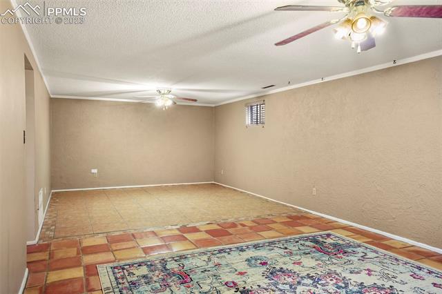 2913 Marilyn Road Colorado Springs, CO 80909 - Photo 27 of 34 Game Room easily holds entertainment area AND play area