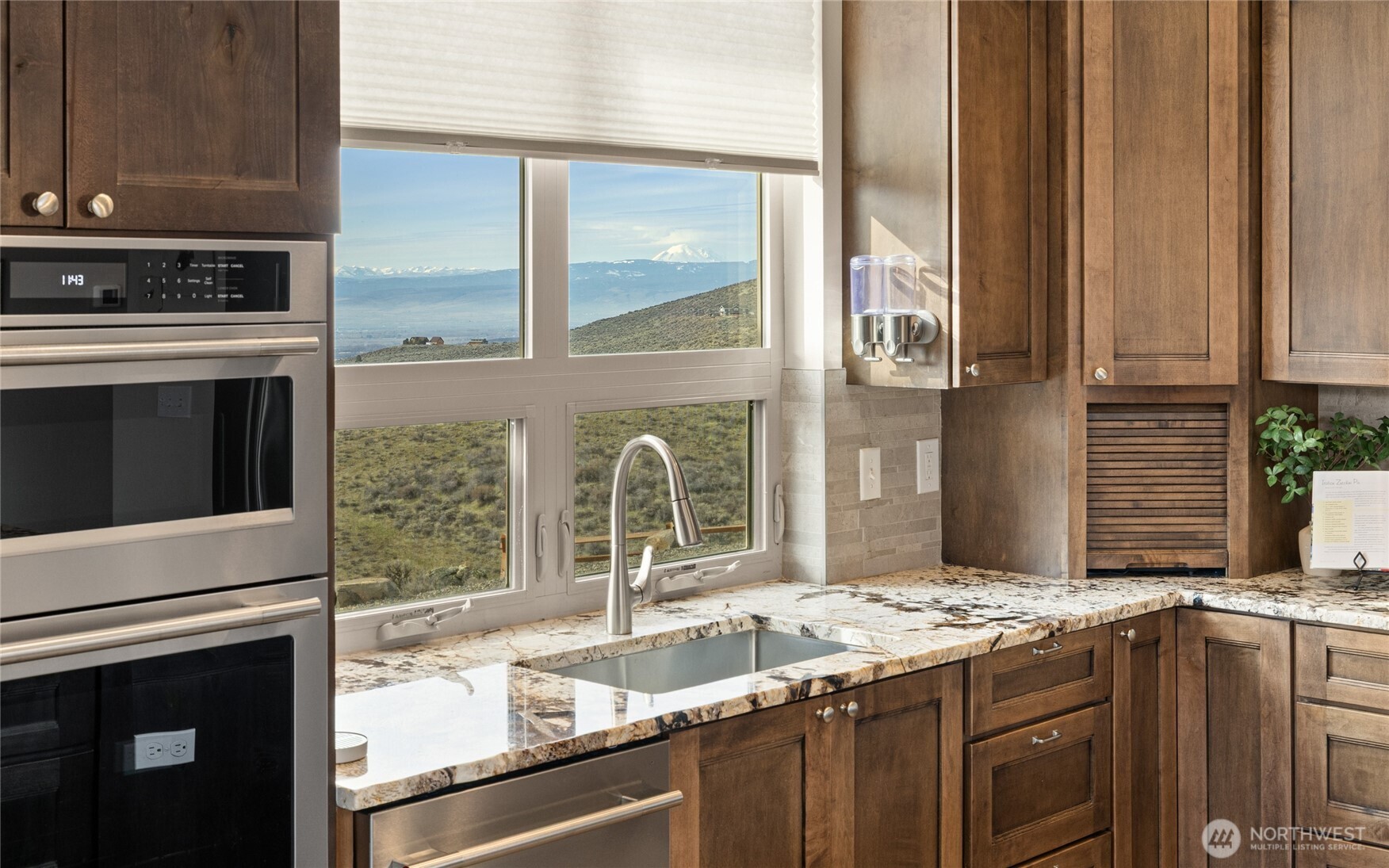 6083 Secret Canyon Road Ellensburg, WA 98926 - Photo 13 of 40 a kitchen with granite countertop a sink stove and cabinets