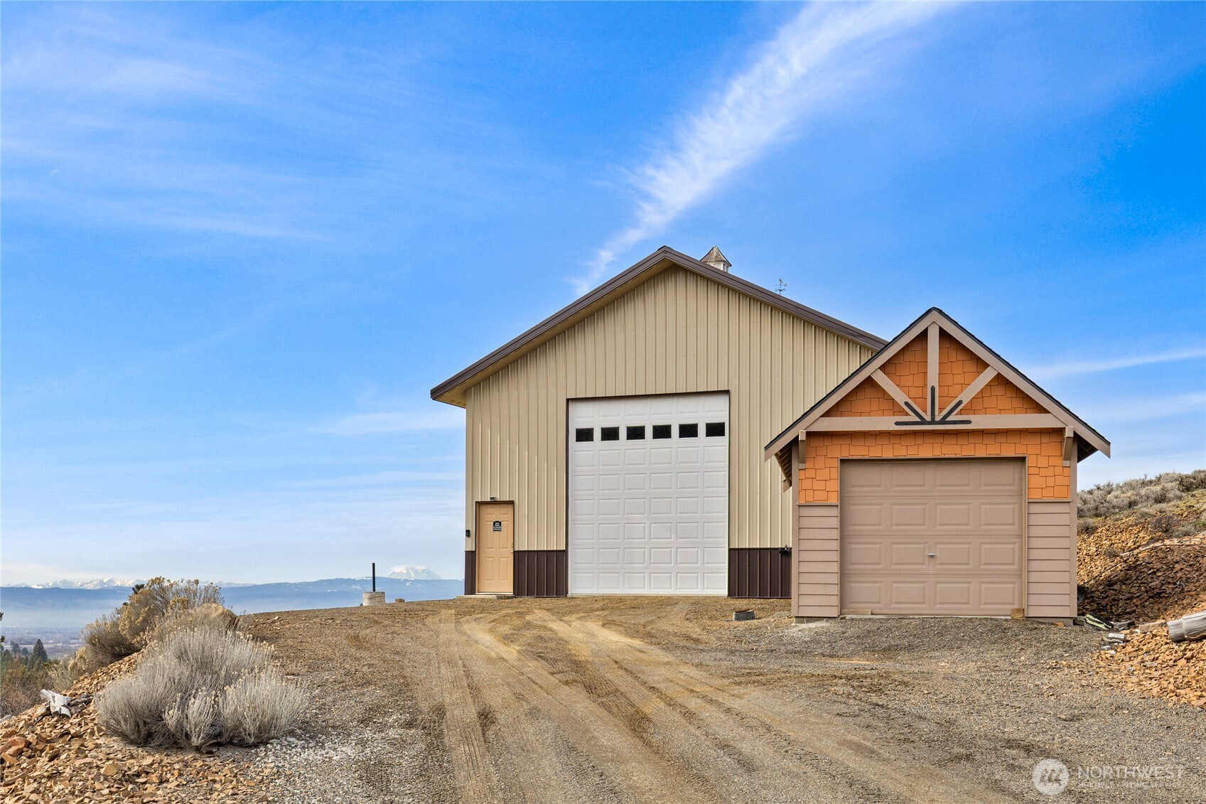 6083 Secret Canyon Road Ellensburg, WA 98926 - Photo 32 of 40 a view of a house with a yard and garage