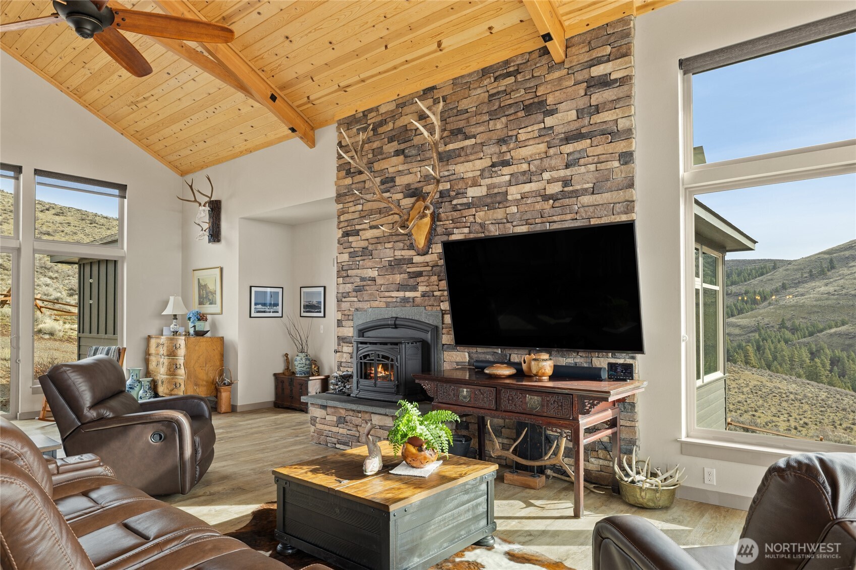 6083 Secret Canyon Road Ellensburg, WA 98926 - Photo 9 of 40 a living room with fireplace furniture and a flat screen tv