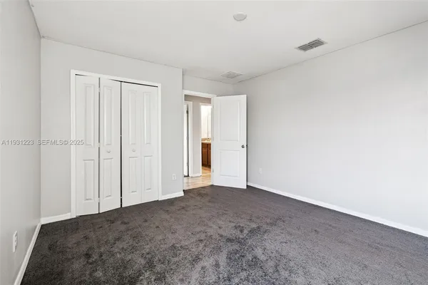 a view of an empty room and closet area