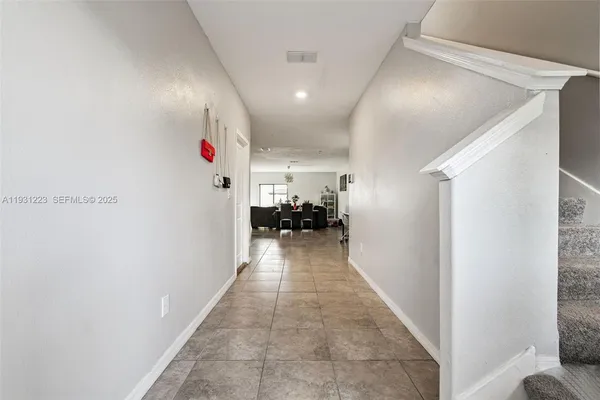 a view of hallway with furniture and a window